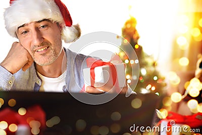 Self absorbed man looking at a christmas present with wish Stock Photo