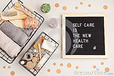 Self care is the new health care. Motivational quote on black letter board with variety of organic body and face care Stock Photo