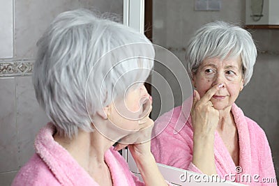 Self conscious mature woman considering a new nose job Stock Photo