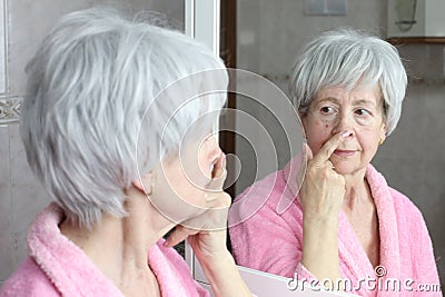 Self conscious mature woman considering a new nose job Stock Photo