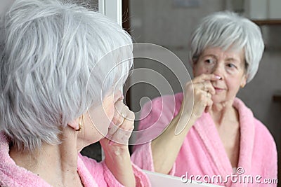 Self conscious mature woman considering a new nose job Stock Photo