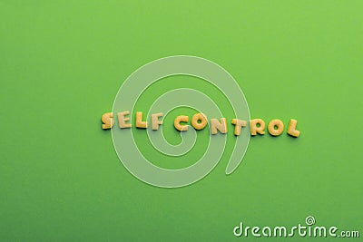 Self controt concept, words made of cookies on green Stock Photo