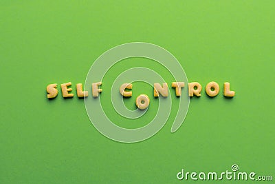 Self controt concept, words made of cookies isolated on green Stock Photo