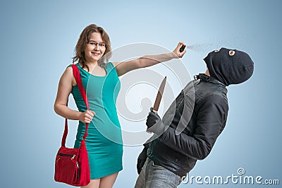 Self defense concept. Young woman is defending herself with pepper spray. Stock Photo