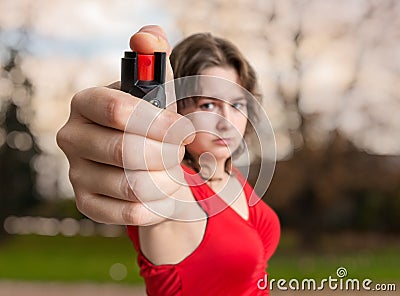 Self-defense concept. Young woman holds pepper spray in hand Stock Photo