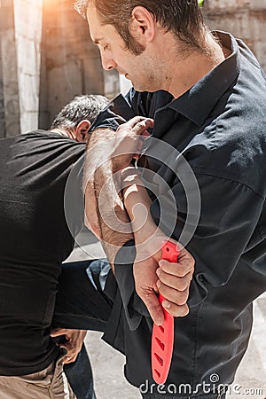 Self defense techniques against a knife attack Stock Photo