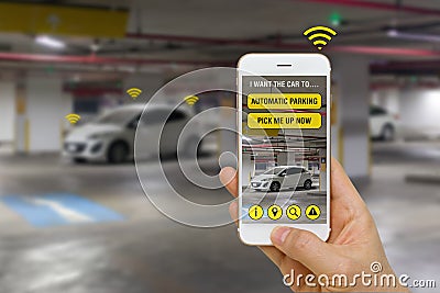 Self-Driving Car Controlled with App on Smartphone to Park in Parking Lot Concept Stock Photo