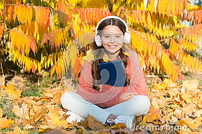 Self education concept. Child enjoy reading. Visual and audio information. Little child enjoy learning at backyard. Kid Stock Photo