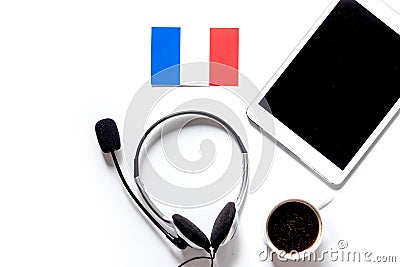 Self-education. Learning french online. Headphones and tablet PC on white table background top view mockup copyspace Stock Photo