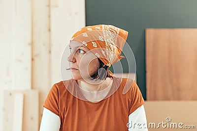 Self employed female carpenter looking out the window Stock Photo
