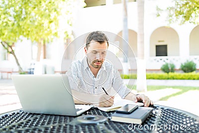 Self-Employed Man Preparing Schedule In Garden Stock Photo