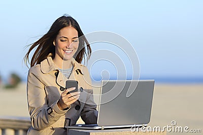 Self employed woman working outdoors on the phone Stock Photo