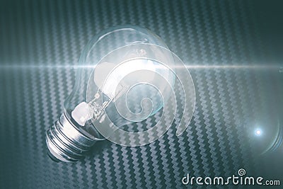 Self illuminating bulb on carbon background. Technology idea con Stock Photo