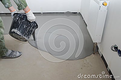 Self-leveling epoxy. Leveling with a mixture of cement floors Stock Photo