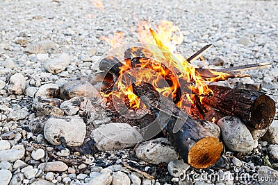 Self-made campfire on shore of mountain river Stock Photo