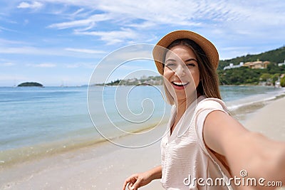 Self portrait of happy stylish young woman on Jurere beach, Florianopolis, Santa Catarina Island, Brazil Stock Photo