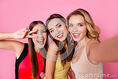 Self portrait of three funny, funky, emotional, expressive, pretty girls, gesture, show peace symbol with two fingers near eye, p Stock Photo