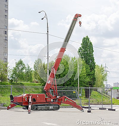 Self propelled crawler crane with telescoping boom on asphalt si Stock Photo