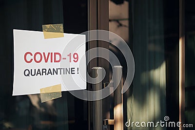 Self quarantine door sign due to novel Coronavirus COVID-19 pandemic, warning texts on white paper stick on home front door in Stock Photo