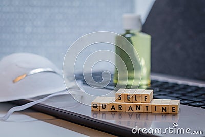 Self Quarantine work remote concept with laptop, hand sanitizer and face mask Stock Photo