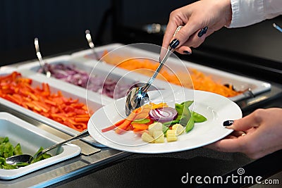 Self service at a salad buffet, catering business vegan food Stock Photo