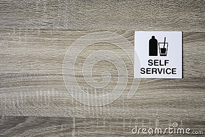 Self service sign on the wooden wall with space for adding text on the left side Stock Photo