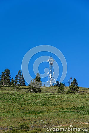 Self-supporting tower loaded with wireless communications antennas on a hilltop in Kittitas County, Eastern Washington State Stock Photo