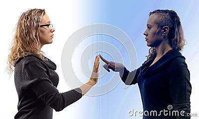 Self talk concept. Young woman talking to herself in mirror reflection. Double portrait from two different side views. Stock Photo