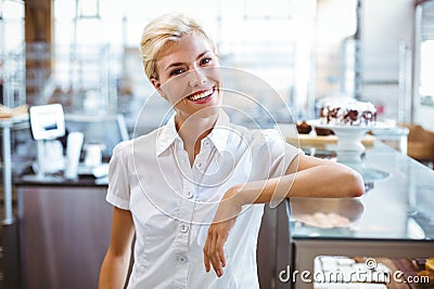 Selfassured female waitress smiling Stock Photo