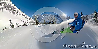 SELFIE: Awesome selfie shot of a snowboarder shredding the fresh powder snow. Stock Photo