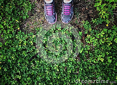 Selfie of feet and sneaker stand on green grass background Stock Photo