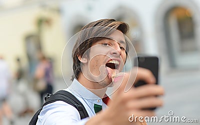 Selfie of handsome young man eating ice cream Stock Photo