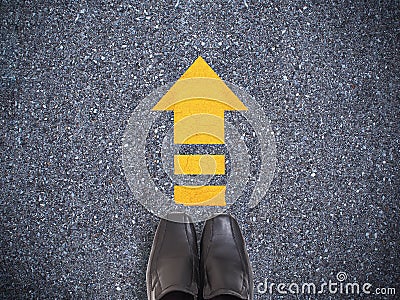 Selfie sneaker black shoes on concrete road with yellow arrow li Stock Photo