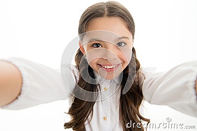 Selfie time. Child school uniform smart kid happy face. Girl cute long curly hair holds smartphone taking selfie white Stock Photo