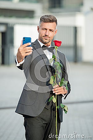 selfie time. man in tuxedo making selfie. man in bowtie outdoor. elegant man taking selfie. Stock Photo