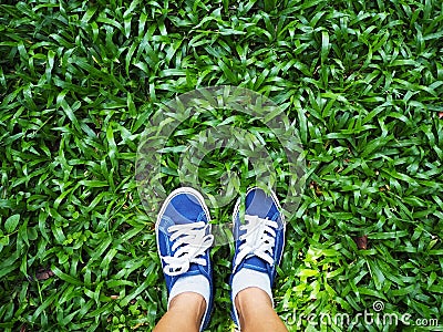 Selfie woman feet wearing blue sneaker on green grass Stock Photo