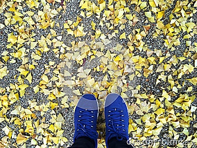 Selfie woman feet wearing blue sneaker and yellow Stock Photo