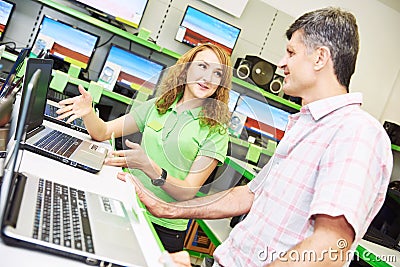 Seller assistant woman help purchaser choosing laptop Stock Photo