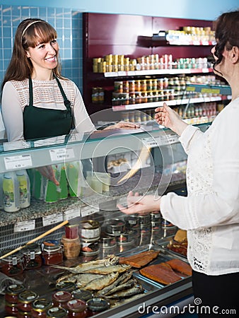 Seller and customer near display with caviar Stock Photo