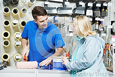 Seller demonstrating paint roller to buyer Stock Photo