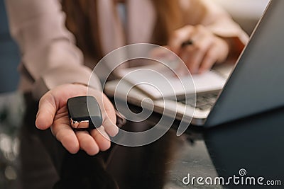 The seller handed over the car keys. in office Stock Photo