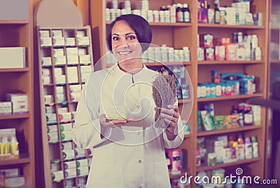 Seller holding dried herbs Stock Photo