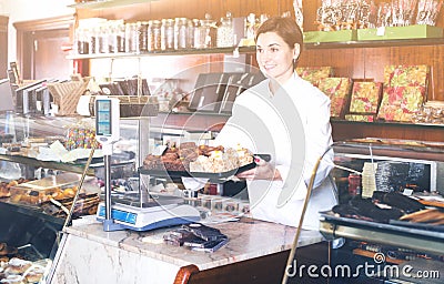 Seller offering tray of cakes Stock Photo