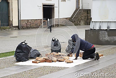 Selling bootleg or African American selling bags in the middle of the street in Porto Editorial Stock Photo