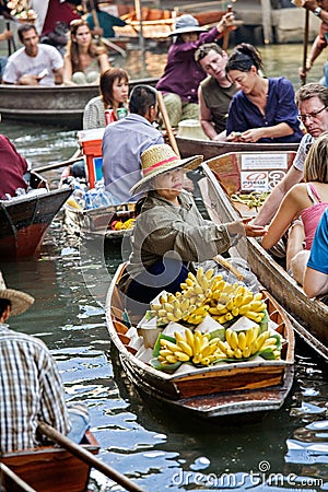 Selling food at the Damnoen Saduak floating market, Bangkok Thailand Editorial Stock Photo