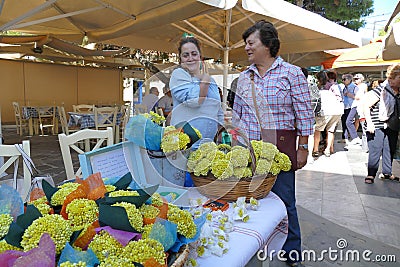 Selling of the typical Kythira suvenir, flowers called 'Sempreviva', characteristic yellow flowers Editorial Stock Photo