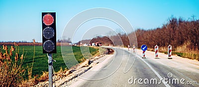 Semaphore traffic light signalization during road maintenance, red stoplight for traffic regulation Stock Photo