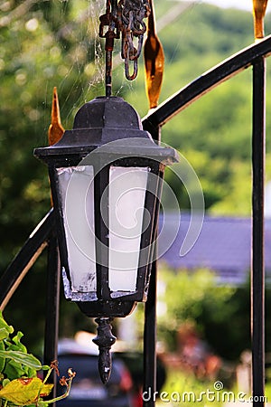 Semi-antique lantern in a web Stock Photo