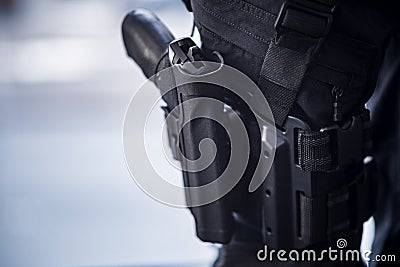 Pistol Holstered on Thigh on Security Personnel Stock Photo