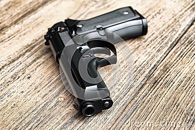 Semi-automatic handgun lying on wooden background., 9mm pistol. Stock Photo